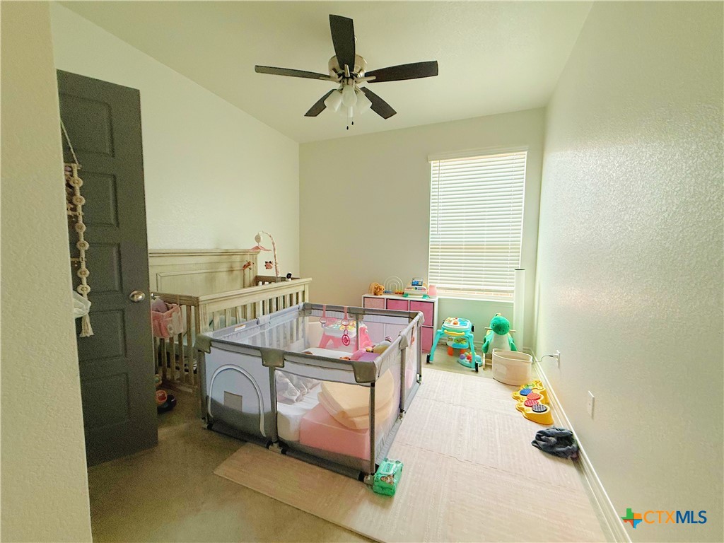 211 Riptide Road Temple, TX 76501 - Photo 10 of 11 a bedroom with a bed and a chandelier