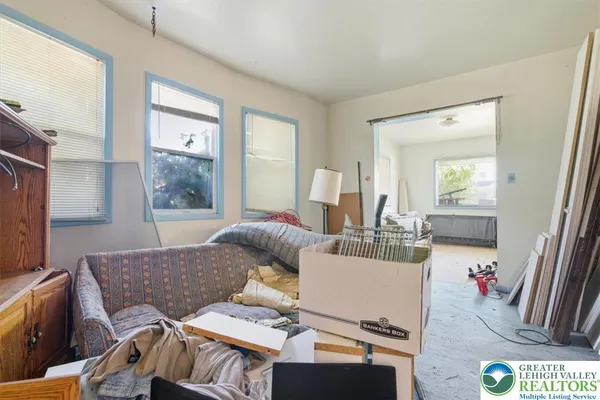 a room with furniture a flat screen tv and a window