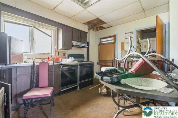 a kitchen with a sink cabinets and appliances