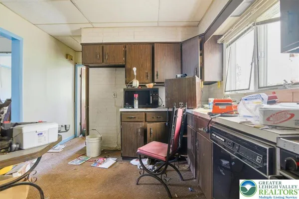 a room with furniture a flat screen tv and windows