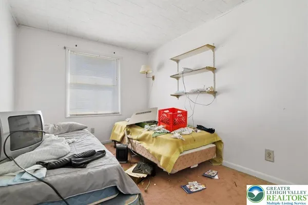 a bedroom with a bed and a couch