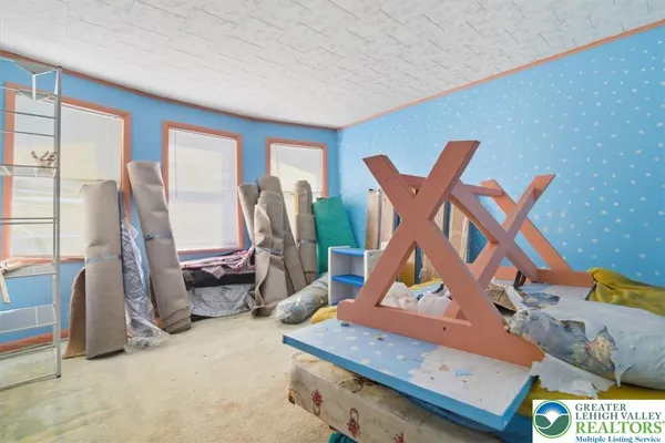 a view of a room with wooden floor and windows