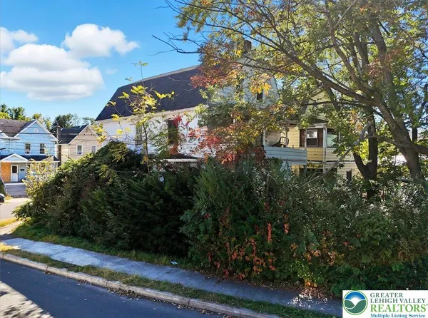 a view of a house with a flower garden