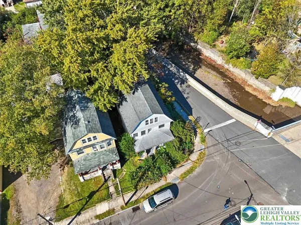an aerial view of residential houses with outdoor space