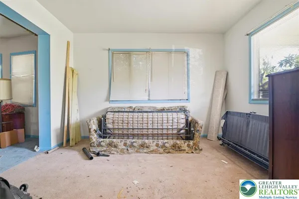 a bedroom with a bed and a large mirror