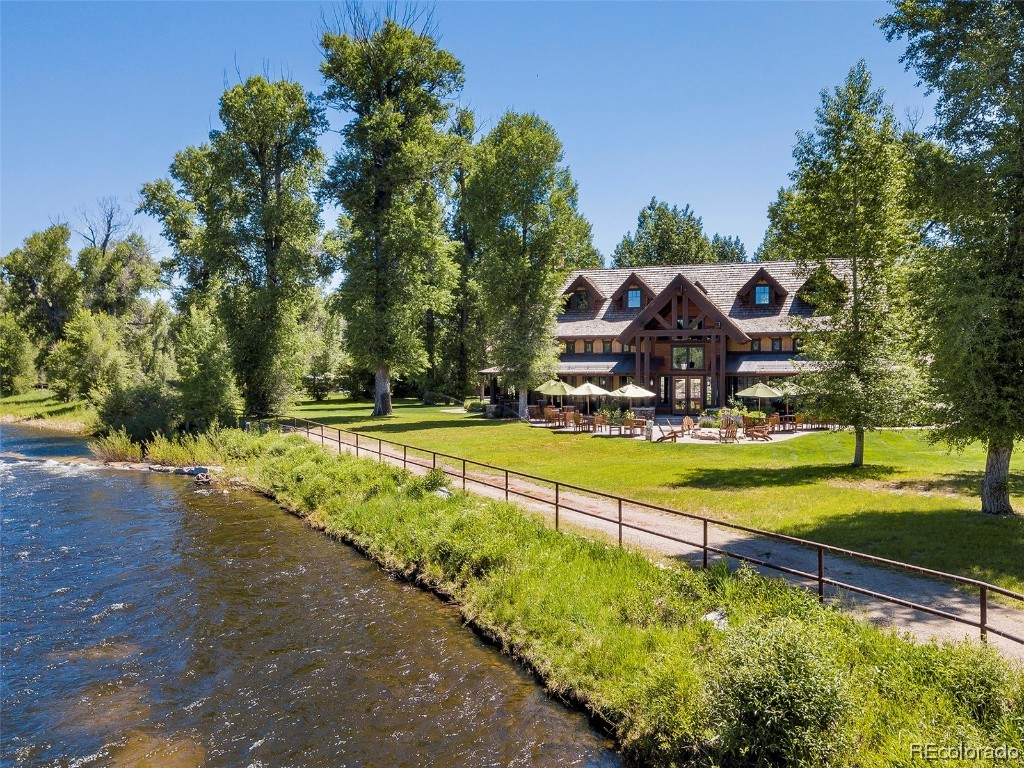 41700 Marabou Loop Steamboat Springs, CO 80487 - Photo 13 of 28 a view of swimming pool with lawn chairs and plants