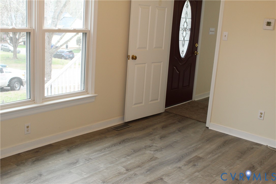 13909 Sagebrook Road Midlothian, VA 23112 - Photo 16 of 41 an empty room with wooden floor and windows