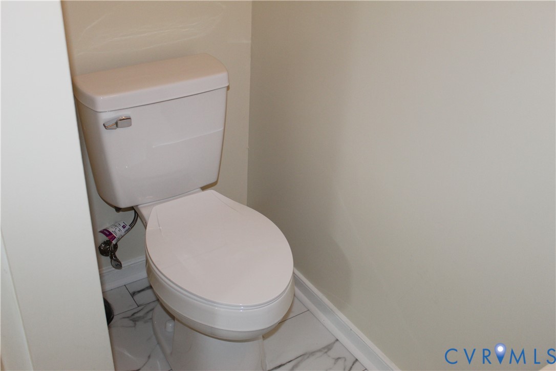 13909 Sagebrook Road Midlothian, VA 23112 - Photo 31 of 41 a white toilet sitting next to a white wall