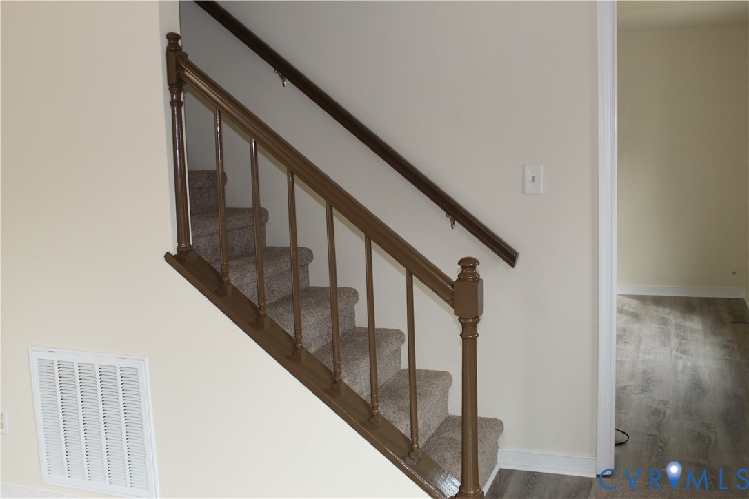 13909 Sagebrook Road Midlothian, VA 23112 - Photo 5 of 41 a view of staircase with wooden floor and white walls