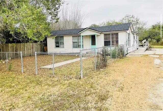 a view of a house with a yard and sitting area