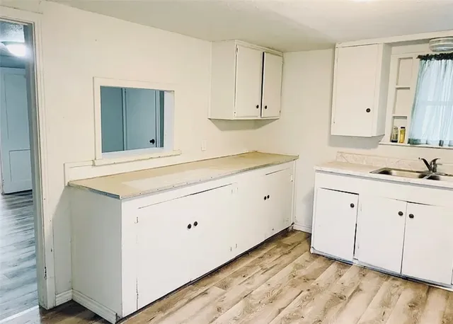 a view white cabinets and a wooden floor