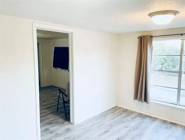 an empty room with windows and closet