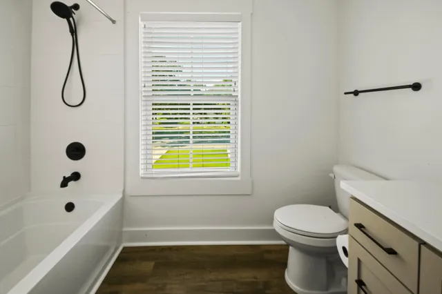 a bathroom with a toilet and a tub