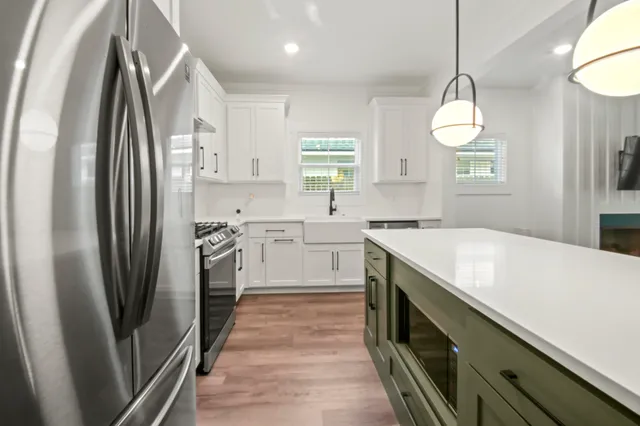 a kitchen with stainless steel appliances a refrigerator sink and cabinets