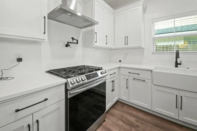 a kitchen with cabinets appliances and a window