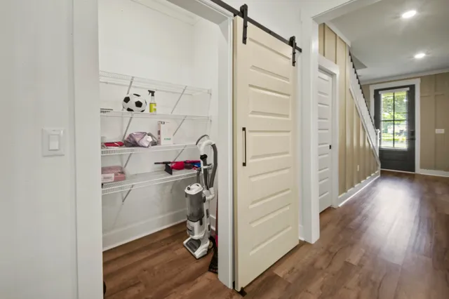 a view of storage and utility room with hardwood floor