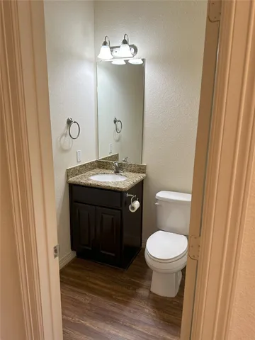 a bathroom with a sink a toilet a mirror and vanity