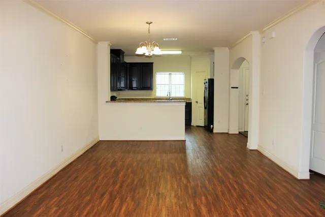 a view of a kitchen with wooden floor and a kitchen