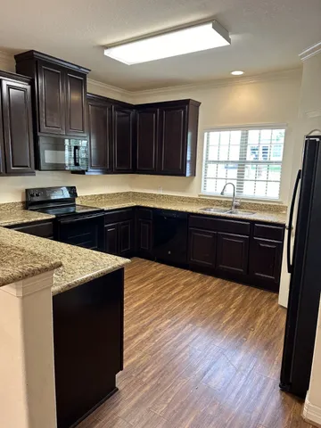 a kitchen with wooden cabinets and sink