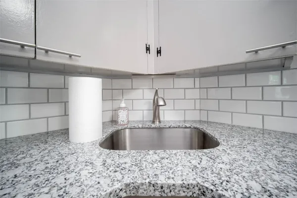 a bathroom with a sink a bathtub and shower