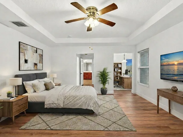 a living room with furniture and a potted plant