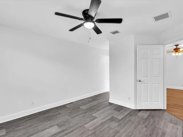 a view of an empty room with a window and front door
