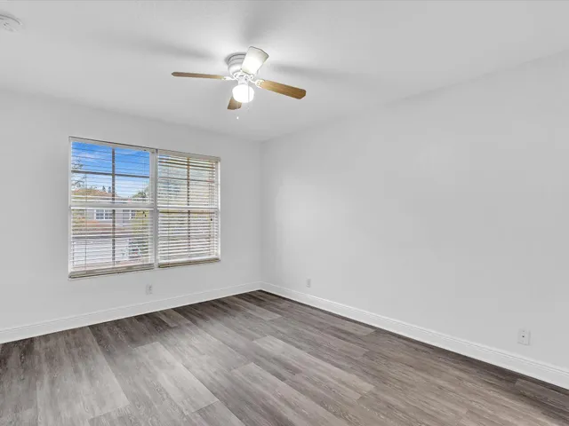 an aerial view of a house with a garden and lake view