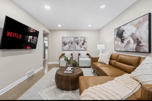 a living room with furniture and a flat screen tv