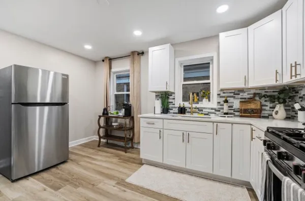 a kitchen with stainless steel appliances granite countertop a refrigerator sink and cabinets