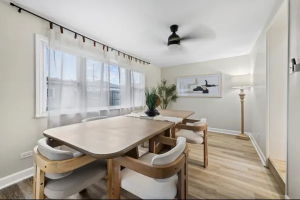 a view of a dining room with furniture and a window