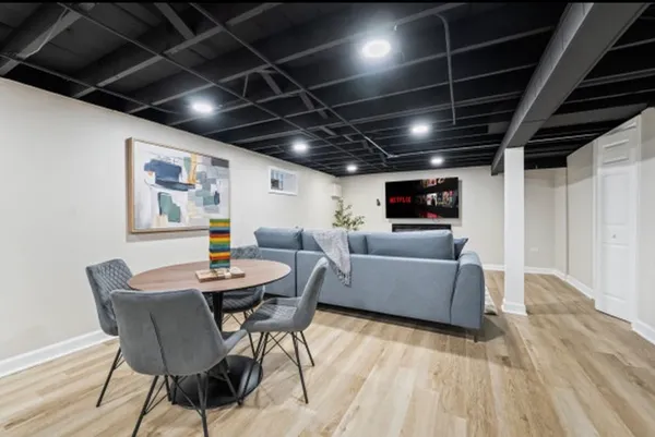a living room with furniture and a wooden floor