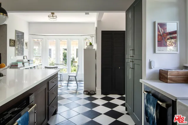 a kitchen with a checkered floor and a sink