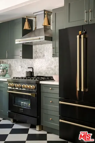 a kitchen with granite countertop a stove and a refrigerator