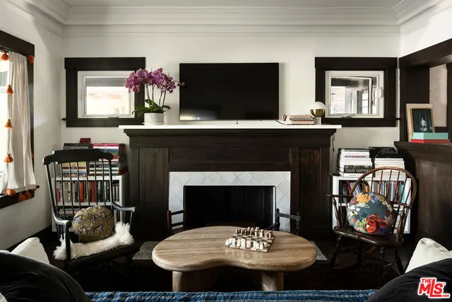 a living room with furniture a flat screen tv and a fireplace