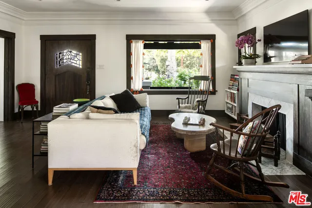 a living room with fireplace furniture and a flat screen tv