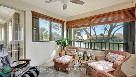 a view of a dining room with furniture and a chandelier