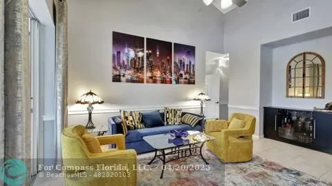 a living room with furniture a flat screen tv and a floor to ceiling window