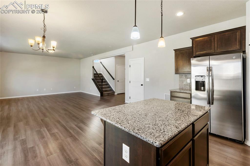 10858 Traders Parkway Fountain, CO 80817 - Photo 13 of 38 a kitchen with kitchen island a counter space a sink appliances and cabinets