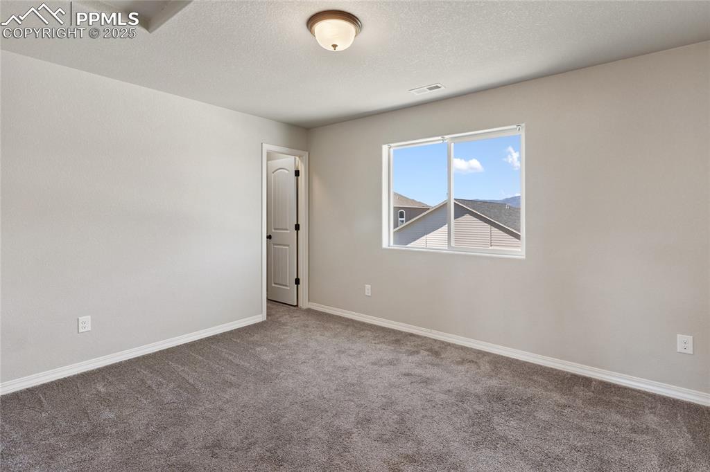 10858 Traders Parkway Fountain, CO 80817 - Photo 31 of 38 an empty room with windows and closet