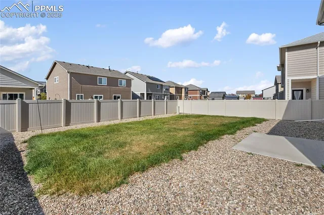 a view of a house with a yard and pathway