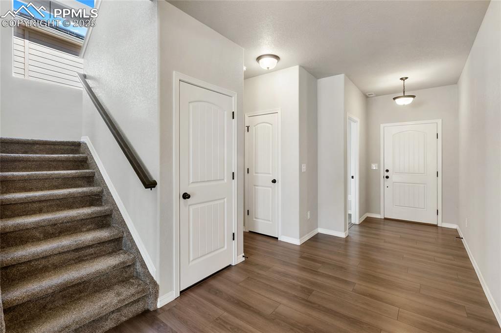 10858 Traders Parkway Fountain, CO 80817 - Photo 4 of 38 a view of a hallway with wooden floor and entryway