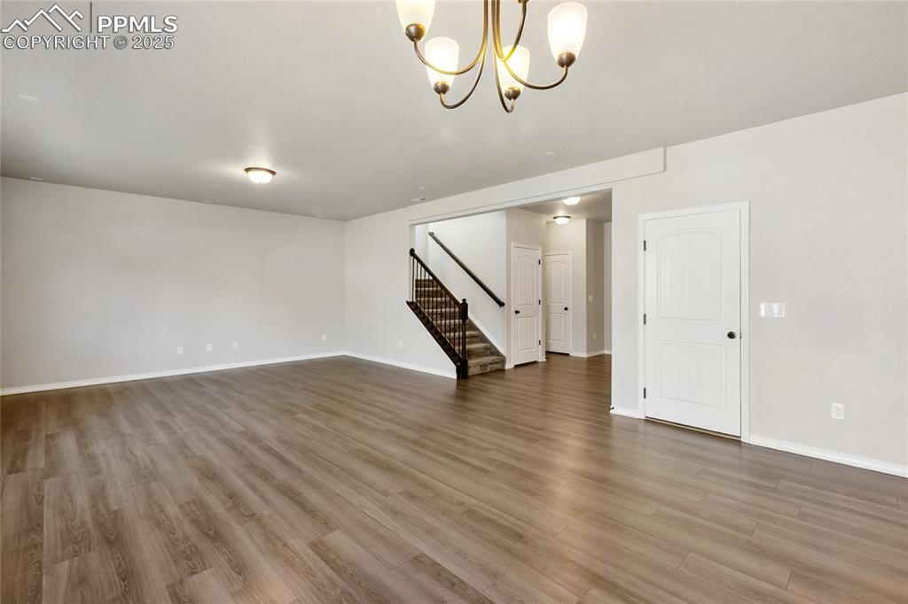 10858 Traders Parkway Fountain, CO 80817 - Photo 5 of 38 a view of an empty room with wooden floor and stairs