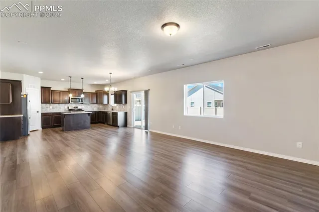 a view of kitchen with furniture and wooden floor