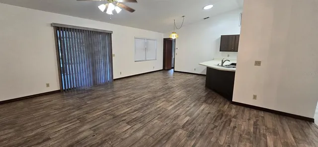 a view of a kitchen with wooden floor and a sink