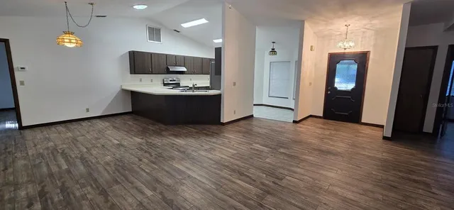 an empty room with wooden floor and mirror