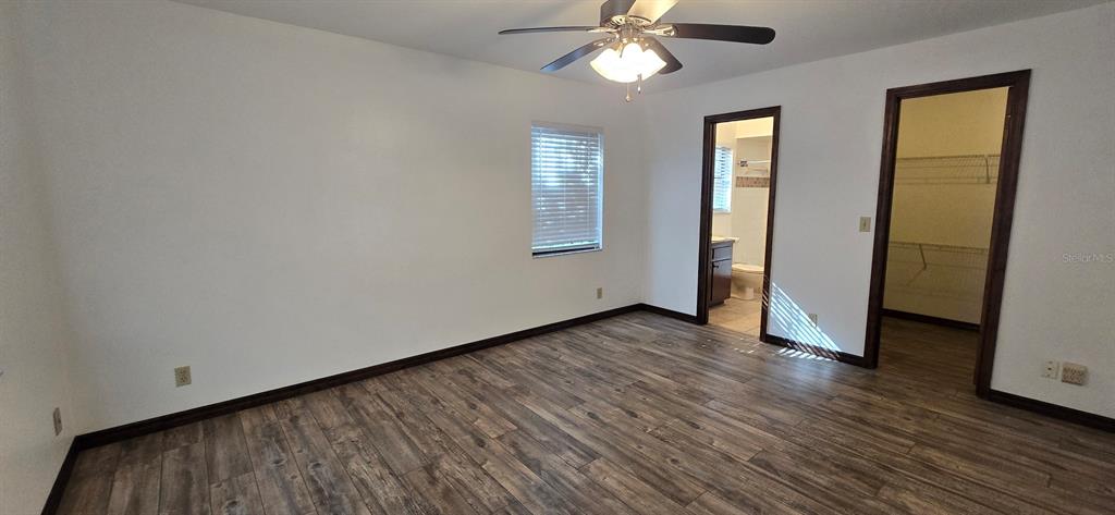 10605 Southwest 68th Terrace Ocala, FL 34476 - Photo 15 of 20 an empty room with wooden floor and windows