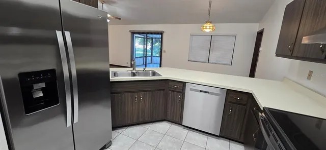 a kitchen with stainless steel appliances a refrigerator and a sink