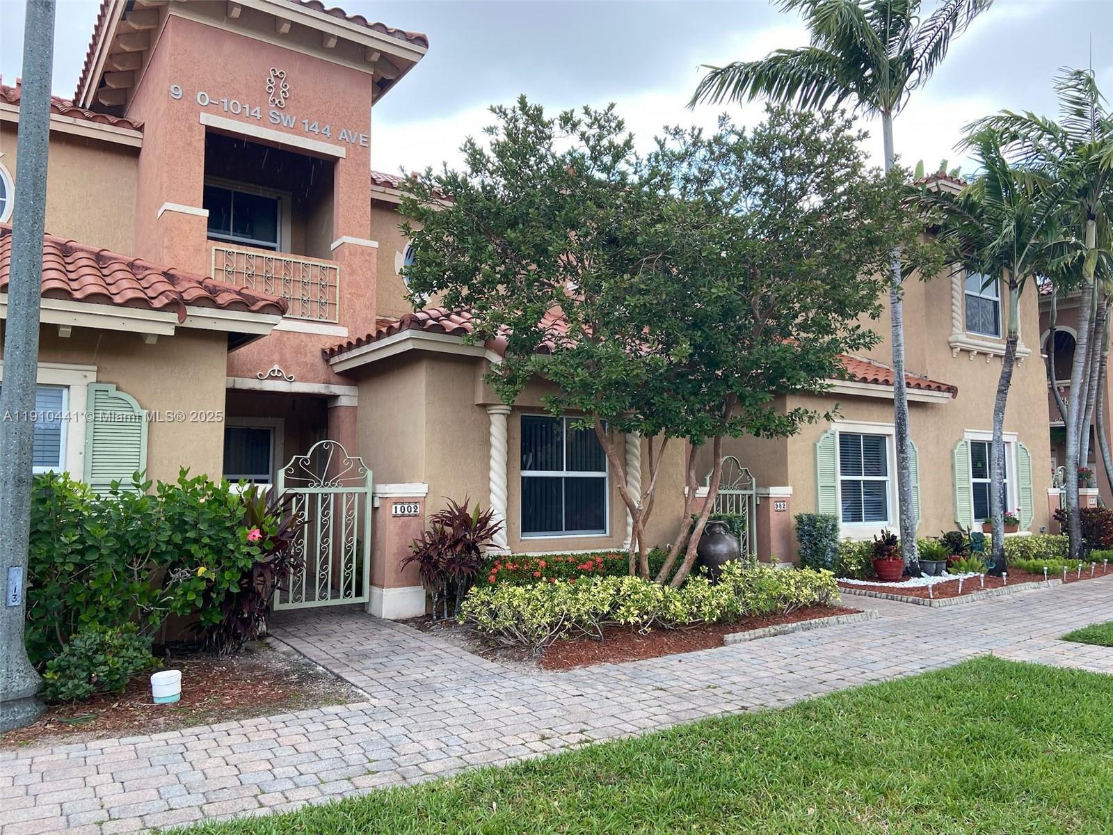 1002 Southwest 144th Avenue, Unit 605 Pembroke Pines, FL 33027 - Photo 1 of 18 a front view of a house with garden