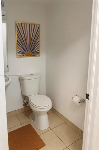 a white toilet sitting next to a bathroom sink