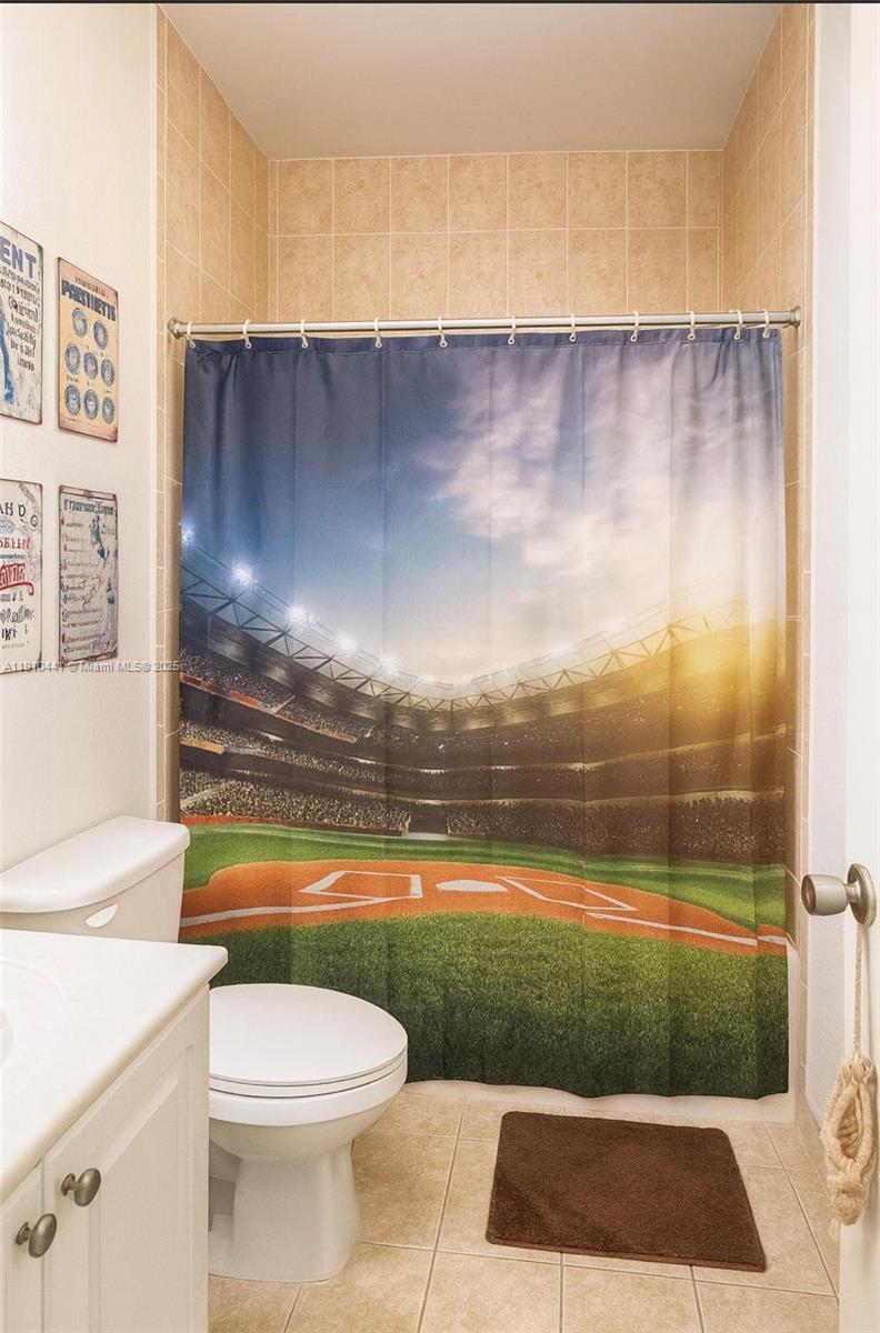 1002 Southwest 144th Avenue, Unit 605 Pembroke Pines, FL 33027 - Photo 13 of 18 a bathroom with a toilet and a shower